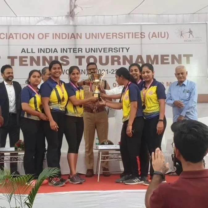 Shamita Yadav celebrating victory at the All India Inter-University Tennis Tournament.